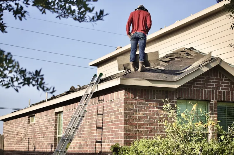 Professional roofer working on a residential roof in McNeil
